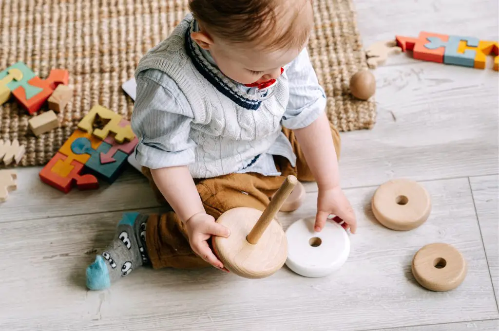 Baby playing with wooden toys